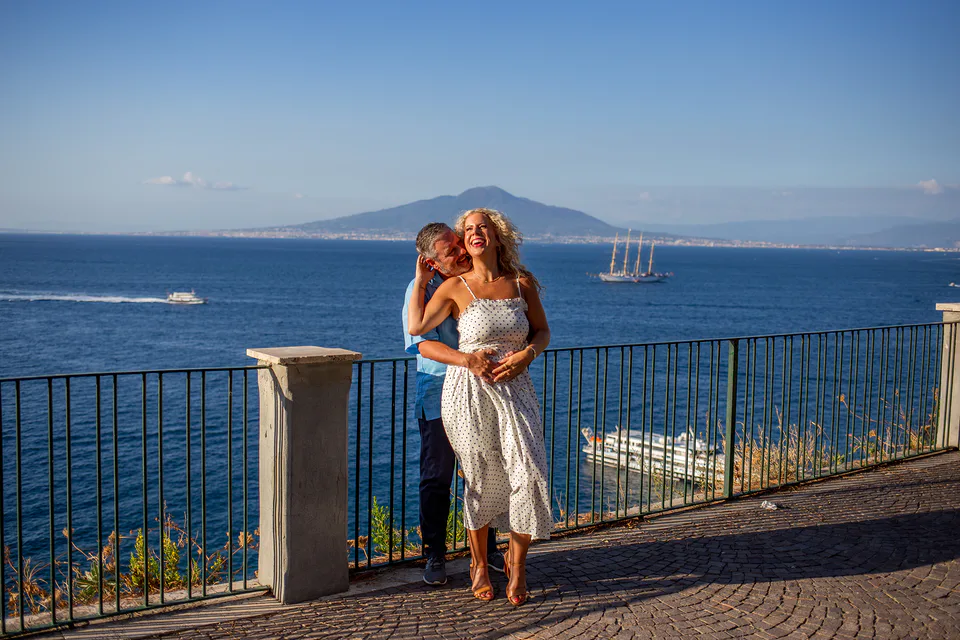 Couple embraced with blue sea behind